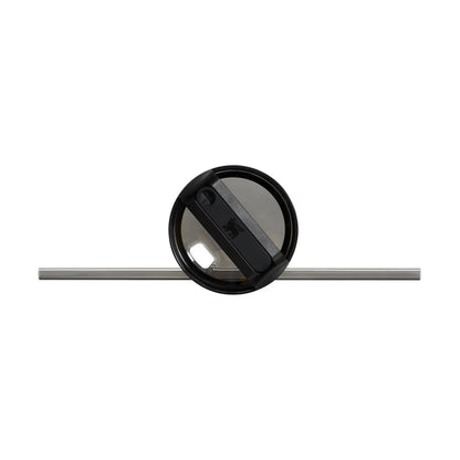 Black circular object with a reflective surface on a white background